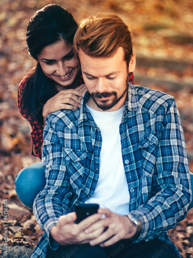 Fun/Couple have fun using smartphone outdoor Fun/Couple have fun using smartphone outdoor