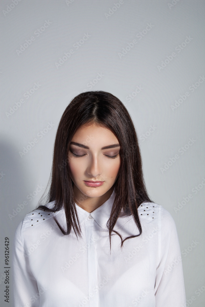Young beautiful woman with closed eyes over white background. Co Young beautiful woman with closed eyes over white background. Co