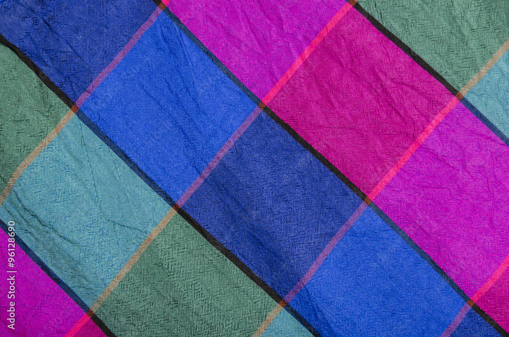 Fototapeta premium Green, green and magenta plaid print as background. Colored square pattern. Checked fabric. Tartan pattern.