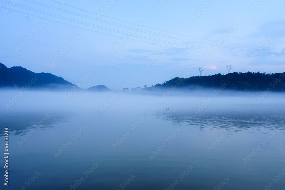 lake in fog in blue sky