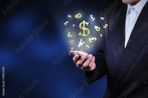 Currency gold symbols fly from a mobile phone