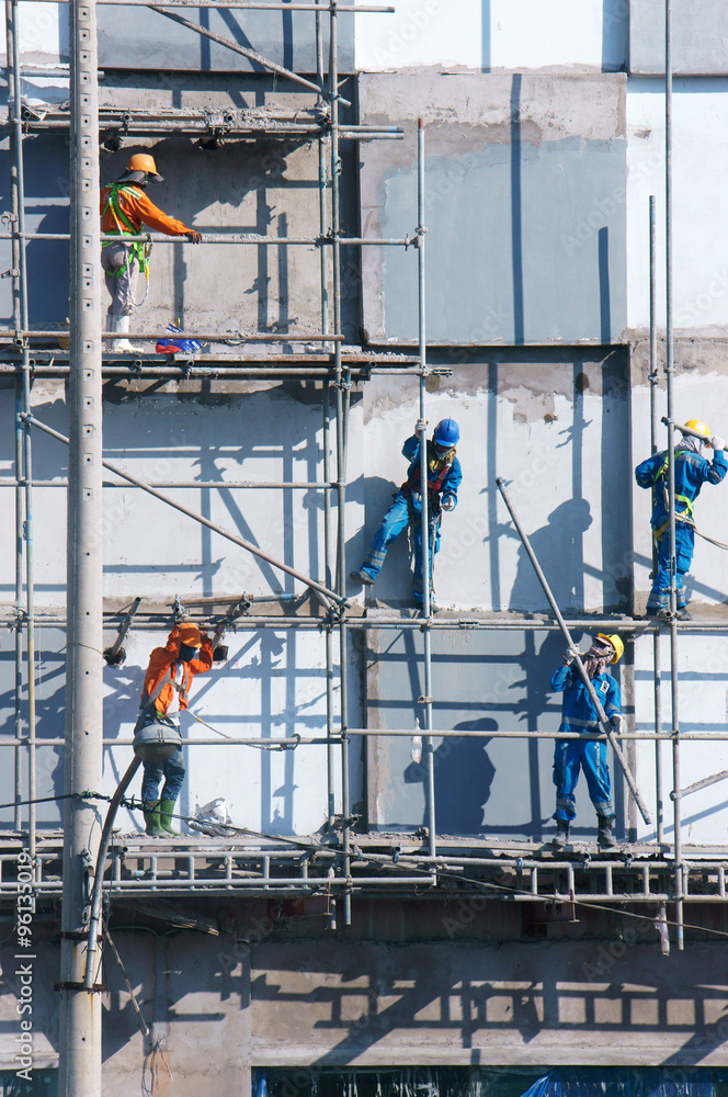 Asian construction worker scraffold, building site Asian construction worker scraffold, building site