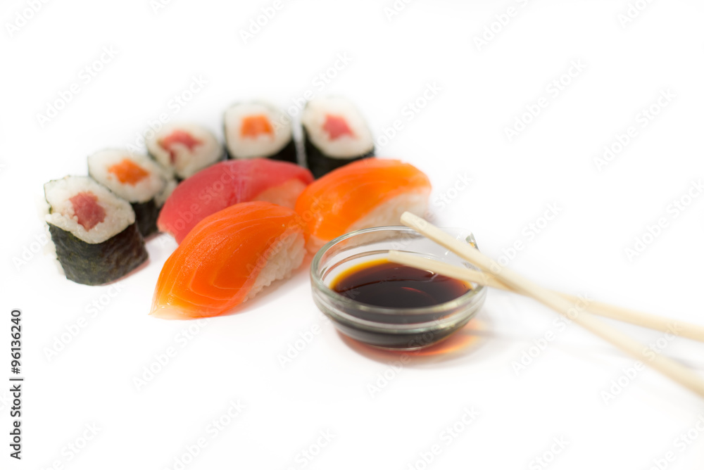 Sushi rolls and nigiri with chopsticks and soy sauce on a white background Sushi rolls and nigiri with chopsticks and soy sauce on a white background