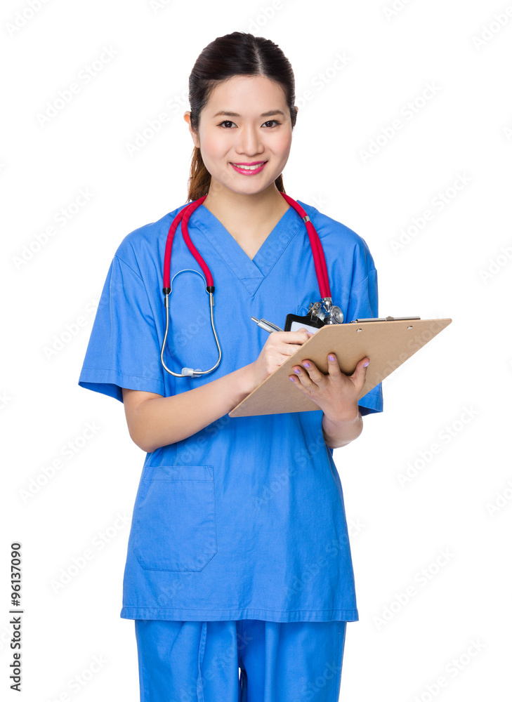 Young Doctor take note on clipboard Young Doctor take note on clipboard