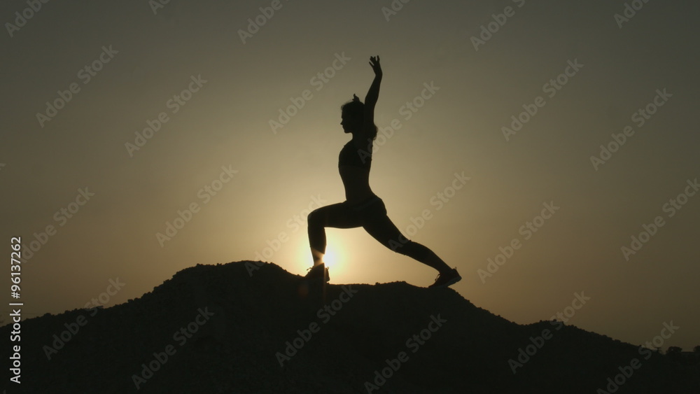 Woman with flexible body practicing yoga positions, doing exercises in mountains Woman with flexible body practicing yoga positions, doing exercises in mountains