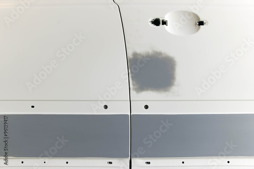 A car is prepared with grey primer.