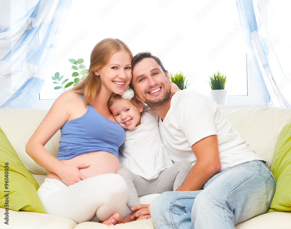 happy family. pregnant mother, father, and child daughter at hom happy family. pregnant mother, father, and child daughter at hom