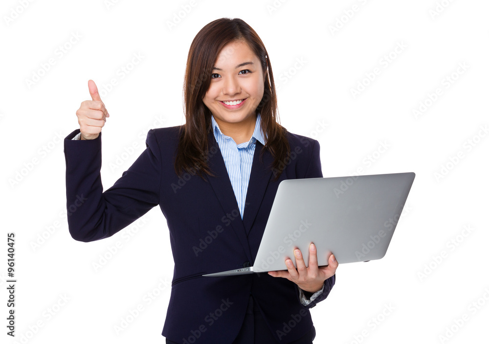 Young Businesswoman use of the notebook computer and thumb up ge Young Businesswoman use of the notebook computer and thumb up ge