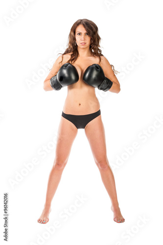 Boxer young girl poses in the studio with boxing gloves