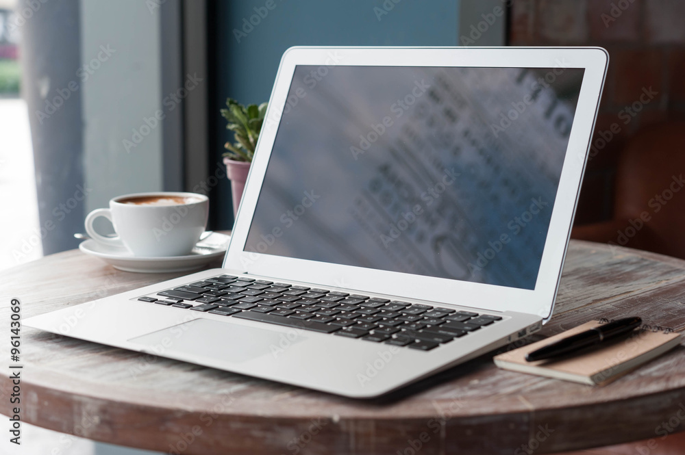 Laptop with tablet, pen and a cup of fresh coffee latte art on w Laptop with tablet, pen and a cup of fresh coffee latte art on w