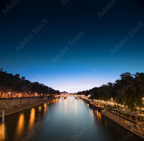 Louvre at night time, a view from a bridge photo