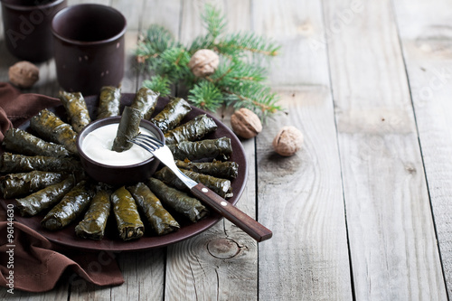 Traditional Caucasian dishes (Dolma), stuffed grape leaves with meat, selective focus photo