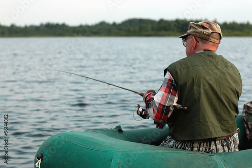 Spinning fisherman on a boat fishing