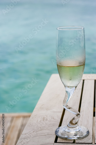 A champagne glasses by the ocean