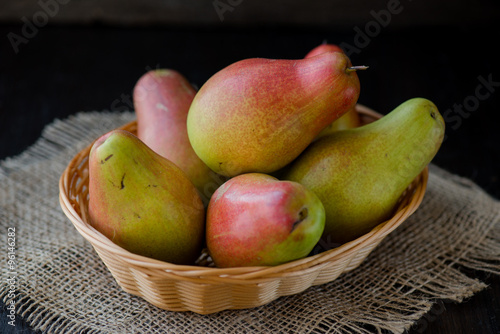 organic pears in the plate, on the wooden background