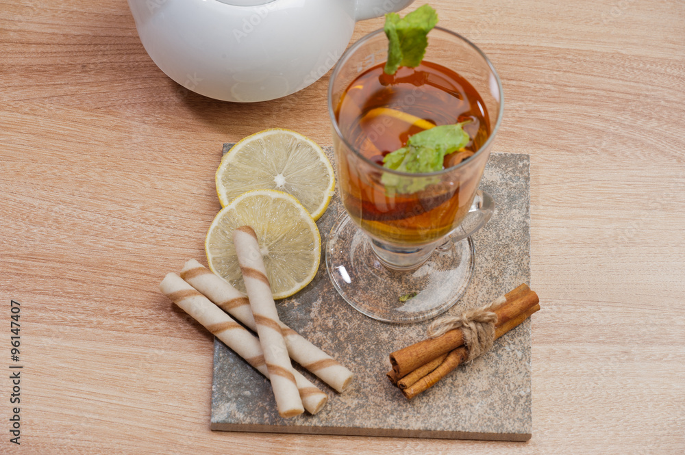 Tea with lemon, cinnamon sticks, tangerine Tea with lemon, cinnamon sticks, tangerine