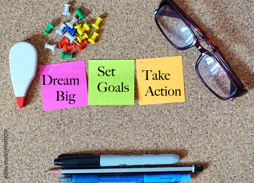 Top View of message note paper stick on cork board with Dream Bi