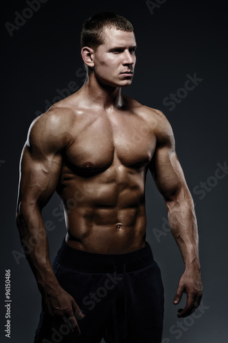 Close-up of a power fitness man. Strong and handsome young man w