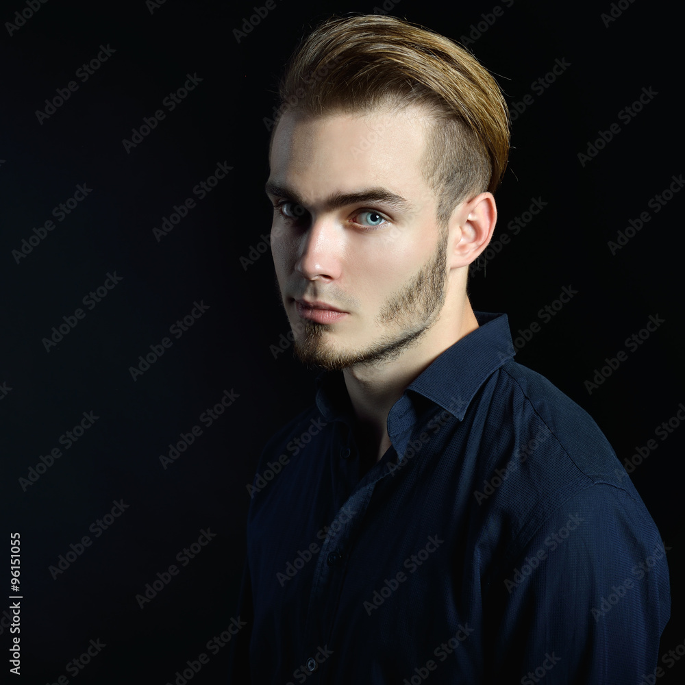 Portrait of beautiful charming young man with blue eyes and fair Portrait of beautiful charming young man with blue eyes and fair