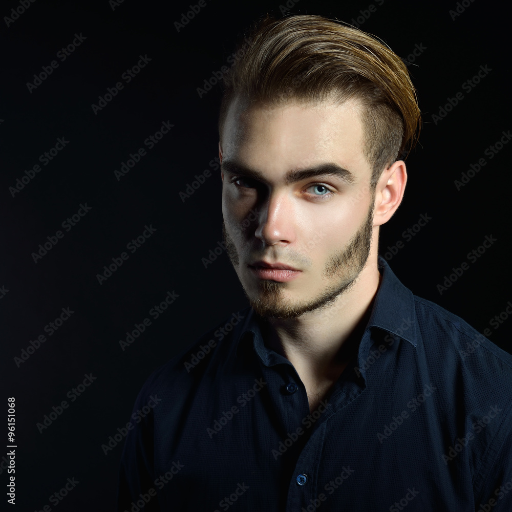Portrait of beautiful charming young man with blue eyes and fair