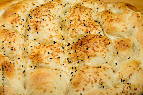 Fragment of turkish bread with sesame seeds. Selective focus © strannik_fox