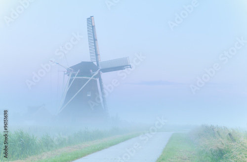 charming windmill in dense fog