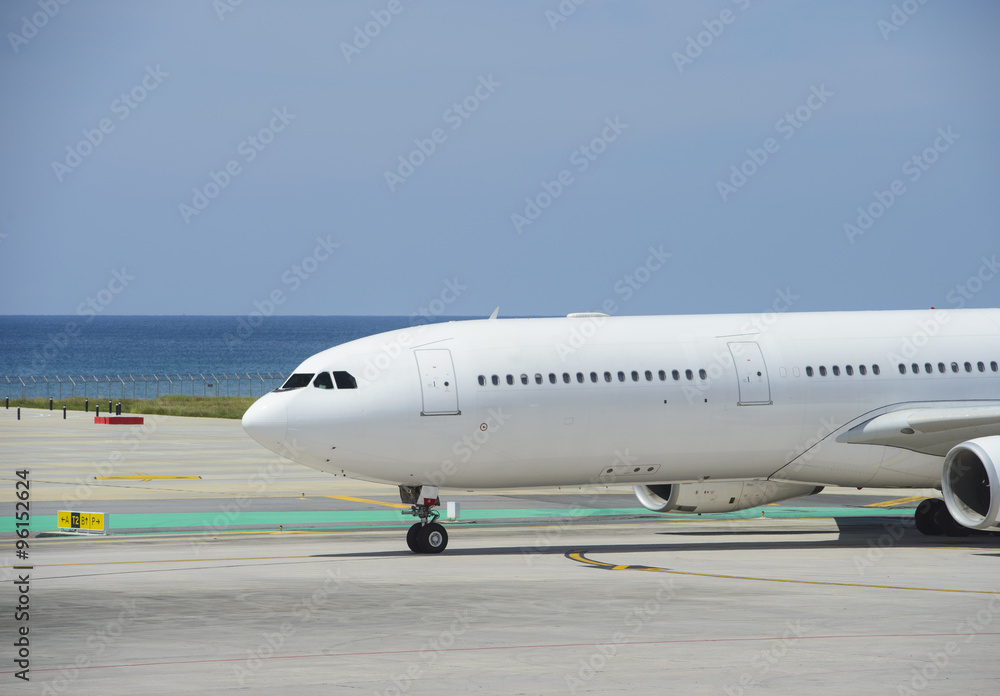 Commercial airplane taxiing on a seashore