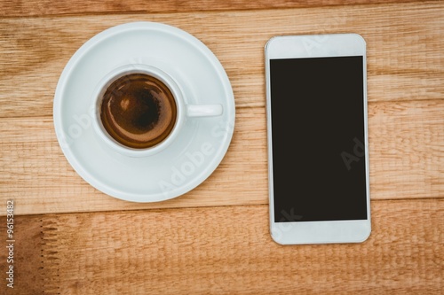 Above view of a coffee and a smartphone