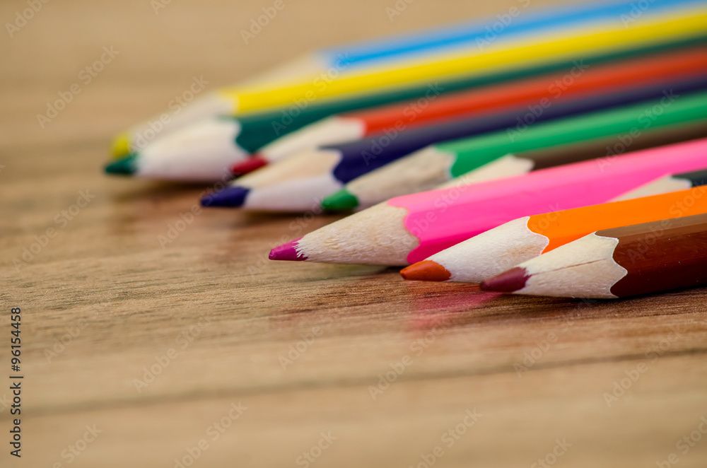 Blank paper and colorful pencils on the wooden table Blank paper and colorful pencils on the wooden table