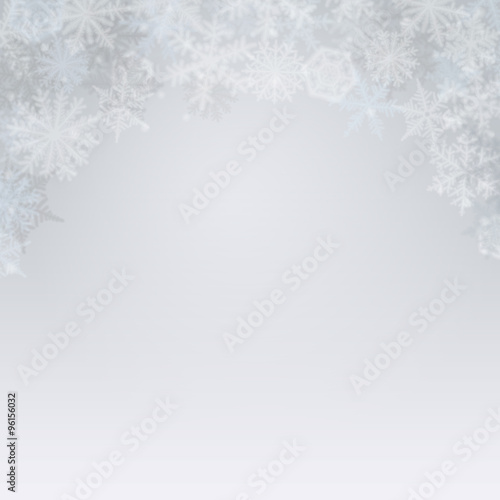 Abstract light winter background with snowflakes.