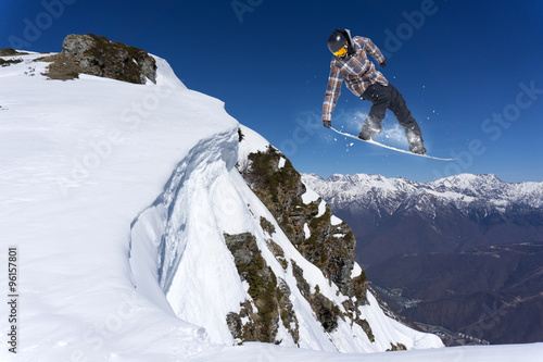 flying snowboarder on mountains