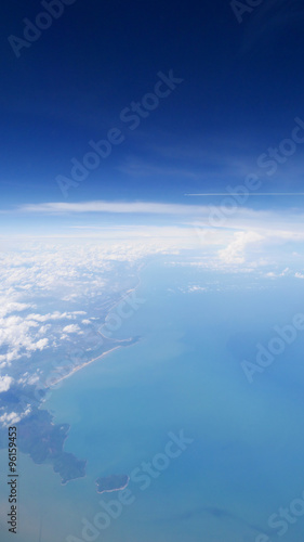 Land and sea under blue sky, view from the airplane. (1)