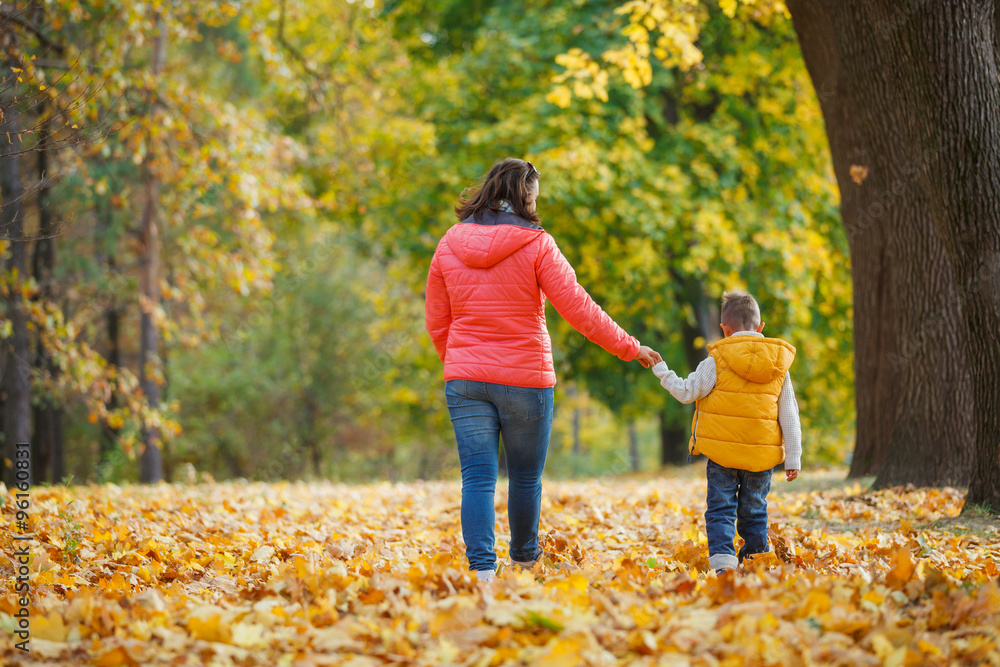Adorable boy with his mother in autumn park Adorable boy with his mother in autumn park