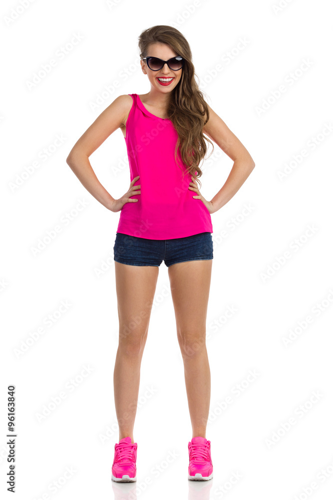 Fototapeta premium Smiling Girl In Pink Shirt. Full length studio shot isolated on white.