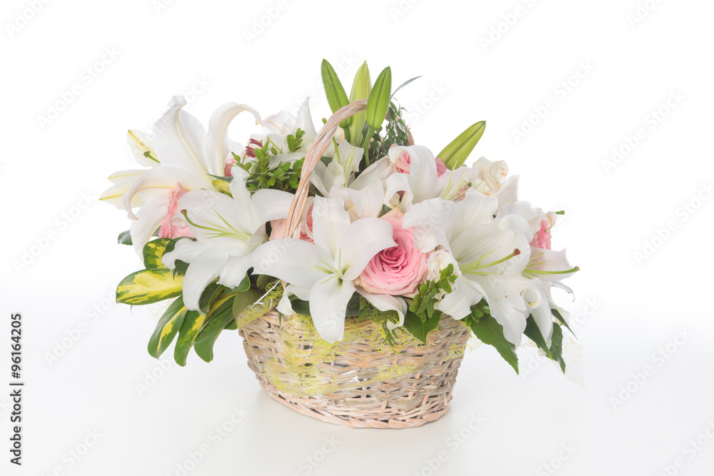Floral arrangement made of lily and Roses in a basket