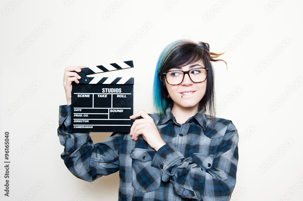 Fototapeta premium Smiling teen woman with clapper board