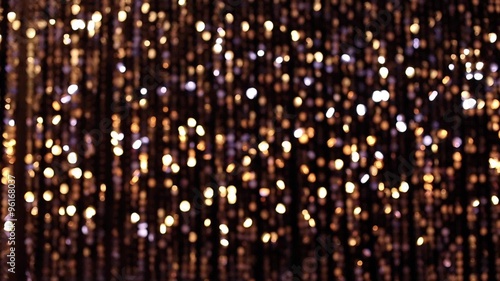 Abstract glittering lights, gold background, a real shot video in the blur