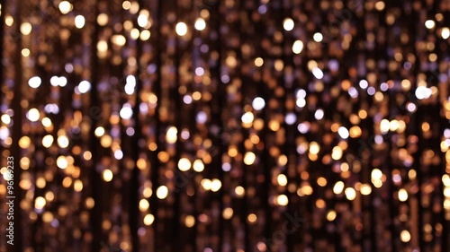 Abstract glittering lights, gold background, a real shot video in the blur