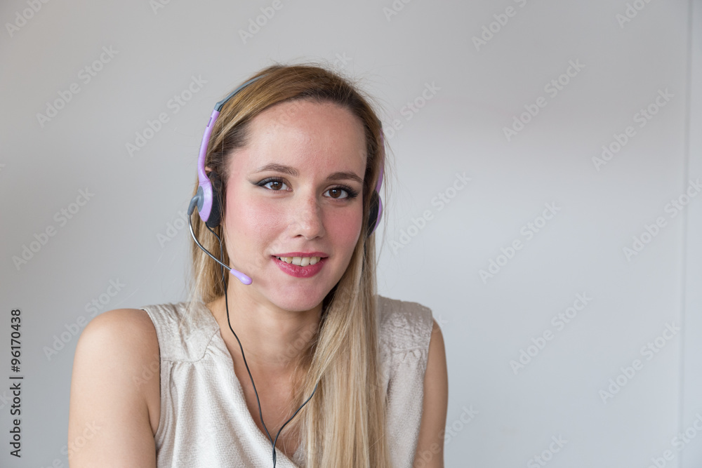 Portrait of attractive smiling blonde woman with headset. Portrait of attractive smiling blonde woman with headset.