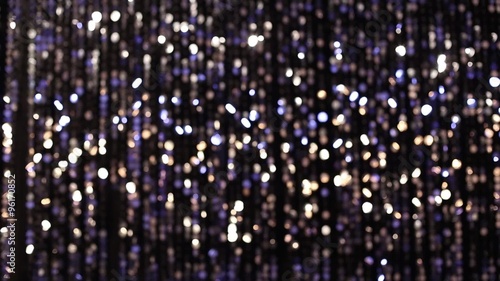 Abstract glittering lights, silver background, a real shot video in the blur