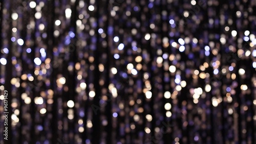 Abstract glittering lights, silver background, a real shot video in the blur