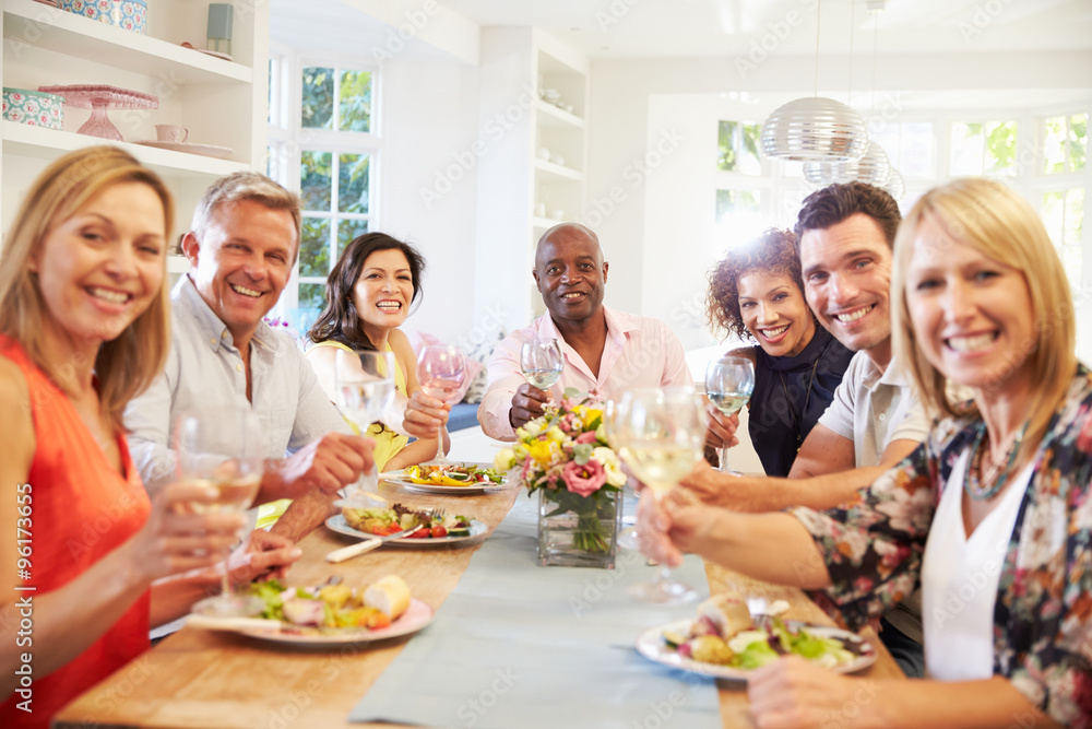 Portrait Of Mature Friends Around Table At Dinner Party Portrait Of Mature Friends Around Table At Dinner Party