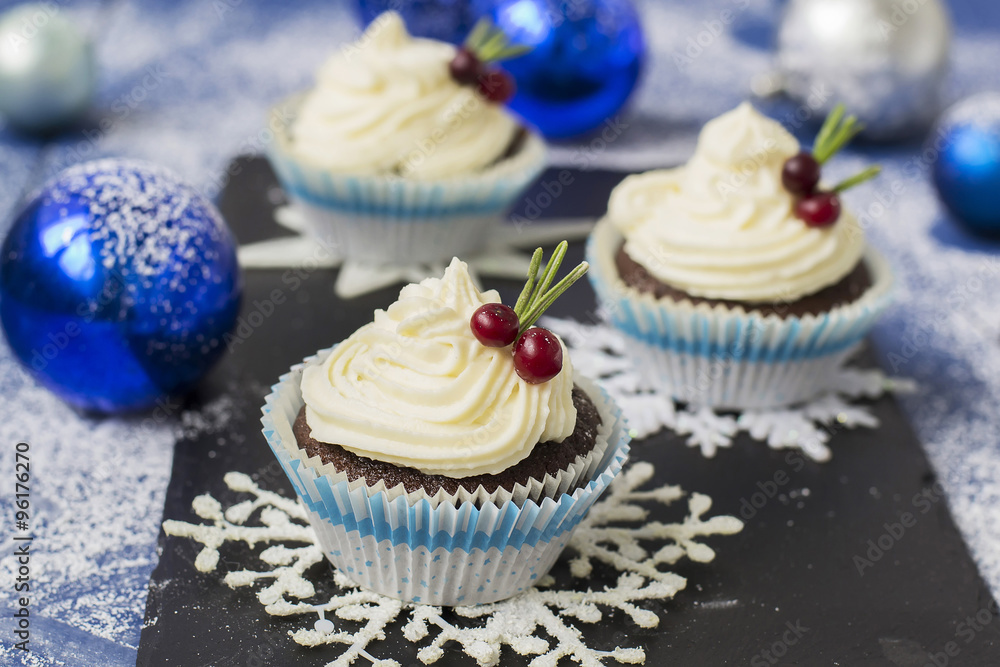 Chocolate cupcake with cream cheese in Christmas decorations