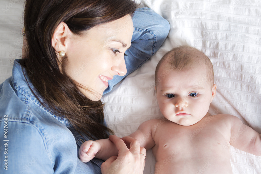 baby and mother in white bed taking good time baby and mother in white bed taking good time