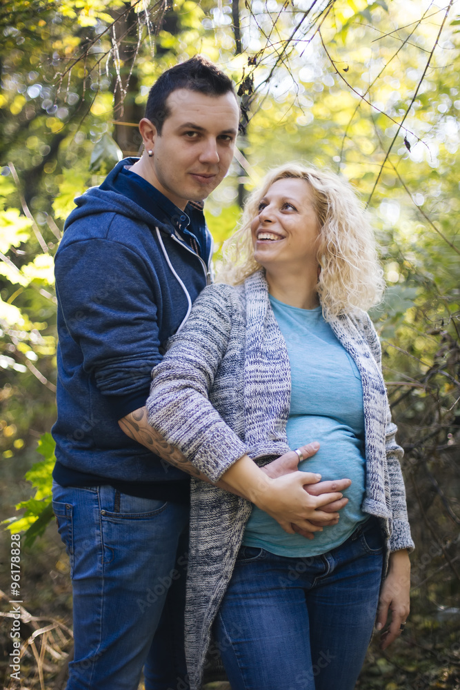 Fototapeta premium Young pregnant couple in the park