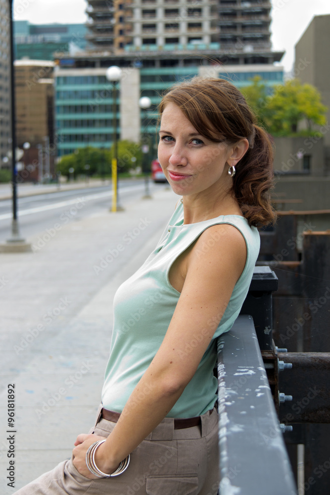 Cute casual young woman smiles in urban city downtown Cute casual young woman smiles in urban city downtown