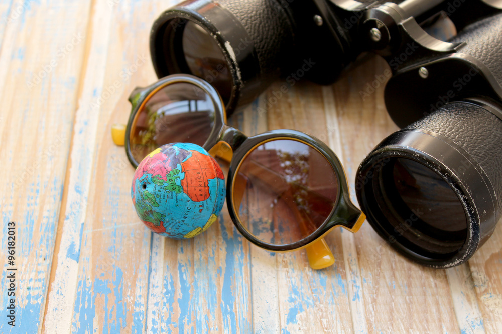 Binoculars, sunglasses and globe 
