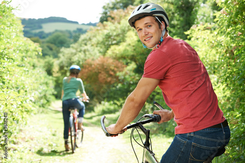 Young Couple Cycling In Countryside