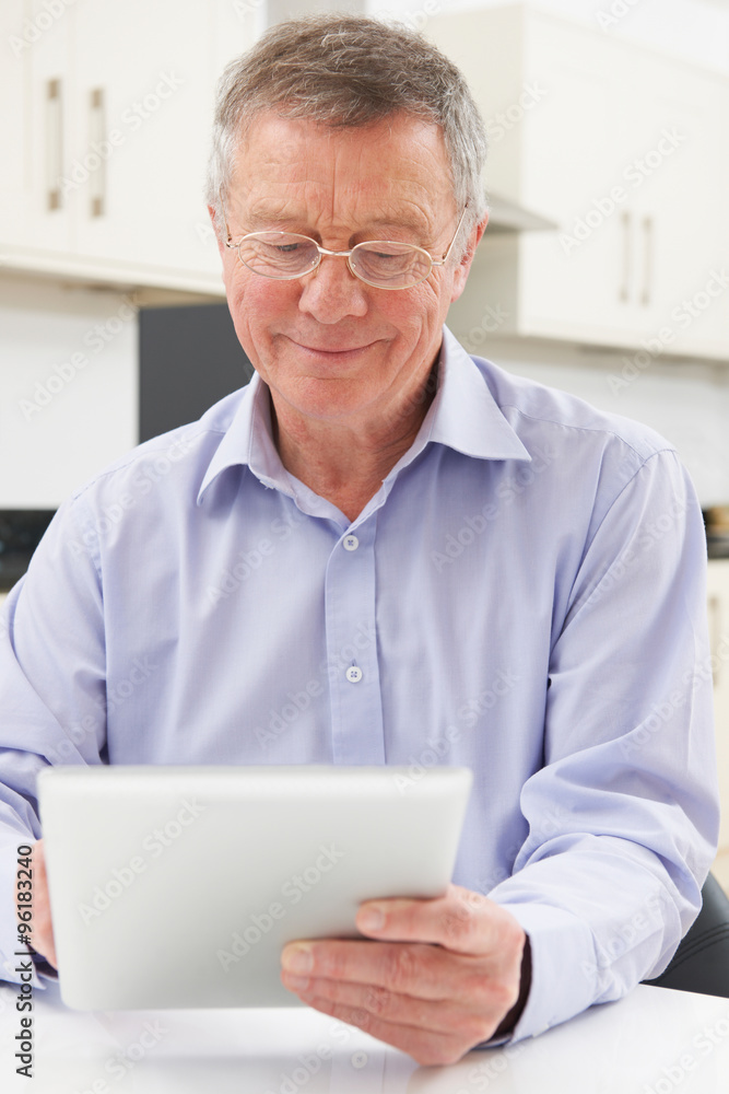 Senior Man Using Digital Tablet At Home Senior Man Using Digital Tablet At Home