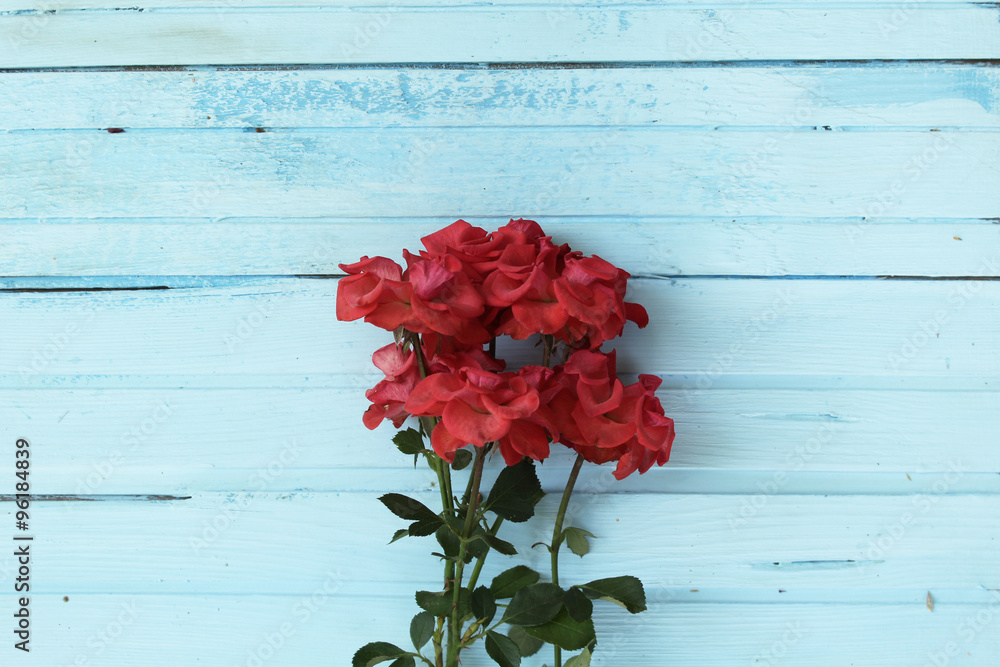 Foral background - red roses on vintage wooden background